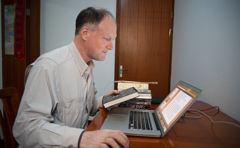 At his home in Shanghai, Craig Brelsford puts the finishing touches on "Shanghai-area Autumn & Winter Birding, 2015-16," one of three reports featured on the new Reports page on shanghaibirding.com. Photo by Elaine Du.