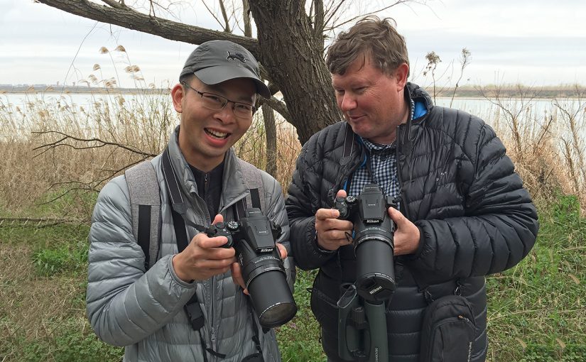 Shanghai Birder KaneXu (L), and Michael Grunwell share a laugh after discovering that they both own the same model of camera, the Nikon Coolpix P900S. (Craig Brelsford)